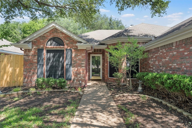 2008 Real Dr, Waco, TX 76712 - view of exterior entry with brick siding and roof with shingles