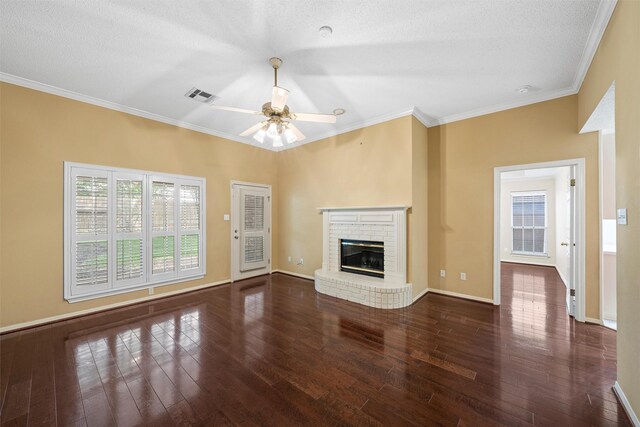 2008 Real Dr, Waco, TX 76712 - unfurnished living room with ornamental molding, a fireplace, wood finished floors, a ceiling fan, and baseboards