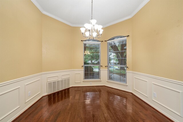 2008 Real Dr, Waco, TX 76712 - unfurnished dining area featuring a chandelier, wood finished floors, ornamental molding, wainscoting, and a decorative wall