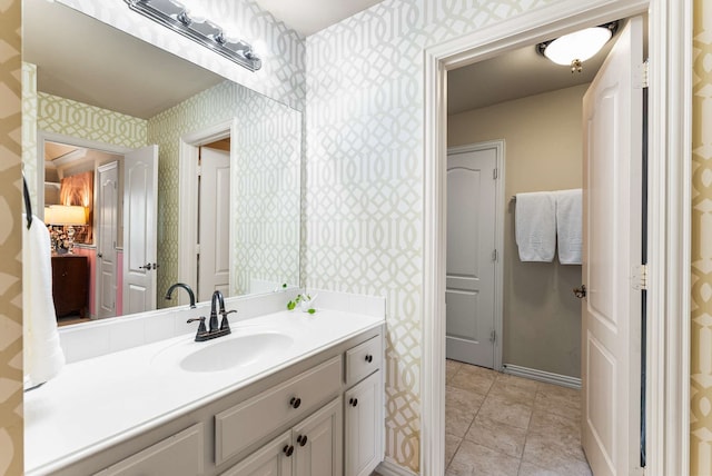 2830 Creekwood Ln, Prosper, TX 75078 - bathroom featuring wallpapered walls, vanity, baseboards, and tile patterned flooring