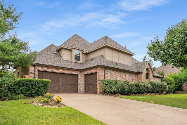 2830 Creekwood Ln, Prosper, TX 75078 - view of front of property featuring board and batten siding, brick siding, a front yard, concrete driveway, and a shingled roof