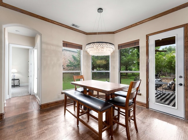 2830 Creekwood Ln, Prosper, TX 75078 - dining space with a chandelier, arched walkways, crown molding, baseboards, and wood finished floors