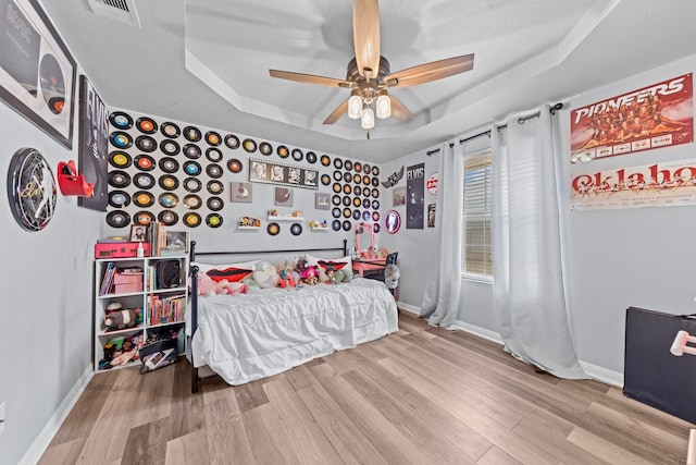 509 Sapphire Blvd, Hewitt, TX 76643 - bedroom with a raised ceiling, wood finished floors, baseboards, and ceiling fan