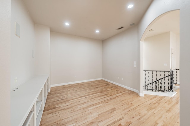 11 Intrepid Cir, Rockwall, TX 75032 - spare room featuring wood finished floors, recessed lighting, arched walkways, and baseboards