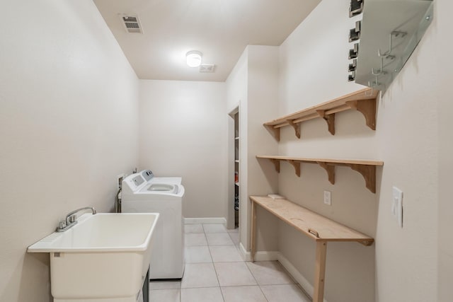 11 Intrepid Cir, Rockwall, TX 75032 - laundry area featuring washer and dryer, light tile patterned floors, and baseboards