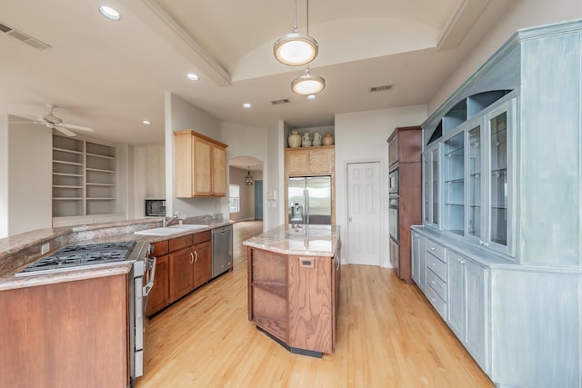 11 Intrepid Cir, Rockwall, TX 75032 - kitchen featuring appliances with stainless steel finishes, arched walkways, light wood-type flooring, ceiling fan, and a sink