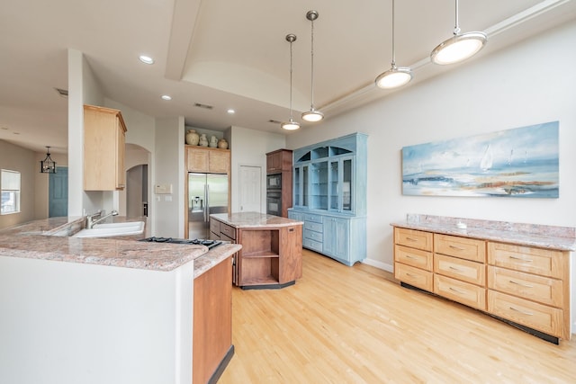 11 Intrepid Cir, Rockwall, TX 75032 - kitchen with black appliances, arched walkways, light wood-style floors, recessed lighting, and open shelves