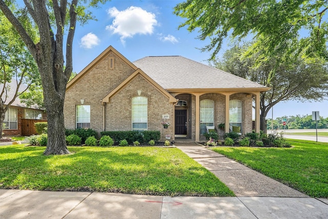 529 Colgate Dr, Allen, TX 75013 - view of front of home featuring brick siding, a front yard, and a shingled roof