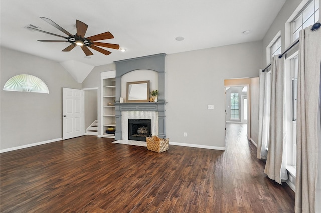 529 Colgate Dr, Allen, TX 75013 - unfurnished living room featuring dark wood-type flooring, ceiling fan, built in features, a tile fireplace, and baseboards
