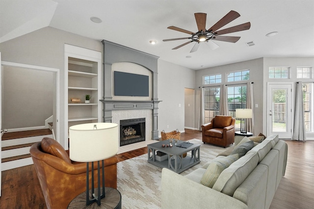 529 Colgate Dr, Allen, TX 75013 - living area with ceiling fan, built in shelves, a fireplace, wood finished floors, and baseboards