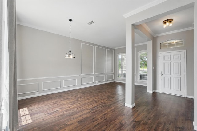 529 Colgate Dr, Allen, TX 75013 - foyer entrance with a decorative wall, crown molding, dark wood-style flooring, arched walkways, and baseboards