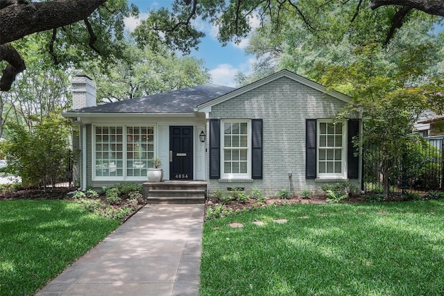 4684 Belclaire Ave, Highland Park, TX 75209 - view of front facade featuring a chimney, a front yard, and brick siding