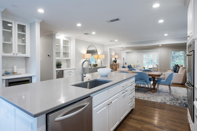 4684 Belclaire Ave, Highland Park, TX 75209 - kitchen with stainless steel dishwasher, a sink, open floor plan, ornamental molding, and recessed lighting