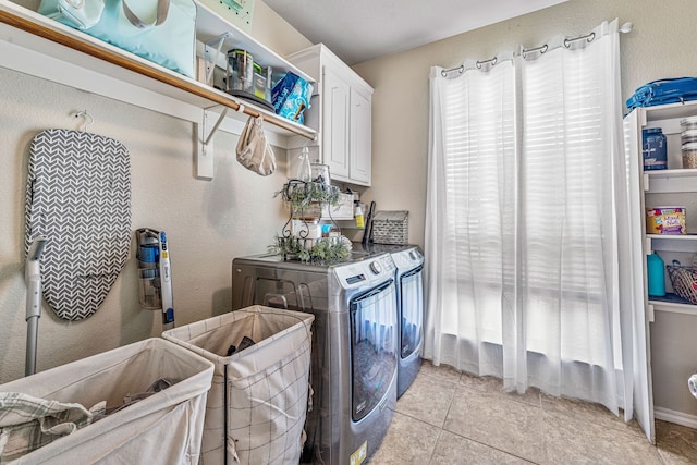 2829 Flint Rock Dr, Fort Worth, TX 76131 - washroom featuring washer and clothes dryer, cabinet space, and light tile patterned floors