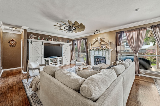 2829 Flint Rock Dr, Fort Worth, TX 76131 - living room featuring plenty of natural light, a textured ceiling, baseboards, ornamental molding, and hardwood / wood-style floors