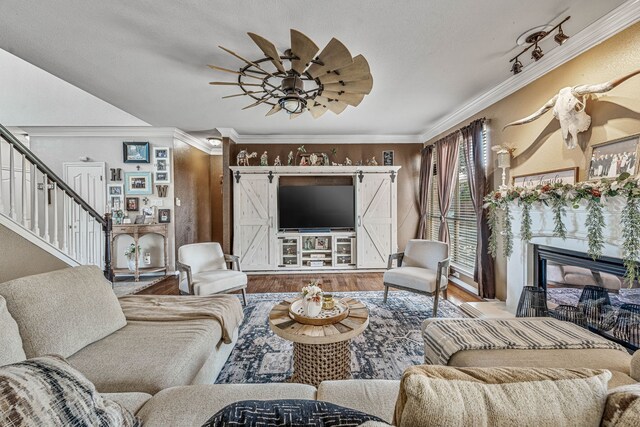 2829 Flint Rock Dr, Fort Worth, TX 76131 - living area featuring stairs, wood finished floors, a premium fireplace, ceiling fan, and crown molding