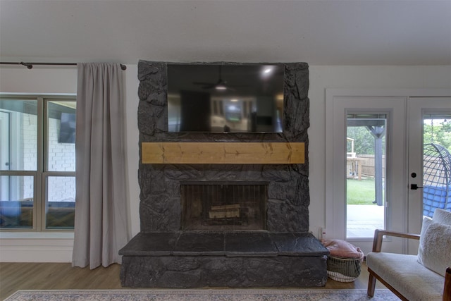 1201 Oakhurst Dr, Southlake, TX 76092 - living room with wood finished floors, a stone fireplace, and a ceiling fan