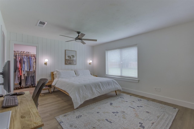 1201 Oakhurst Dr, Southlake, TX 76092 - bedroom with a walk in closet, a closet, wood finished floors, baseboards, and a ceiling fan
