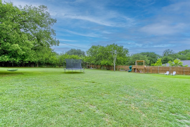 1201 Oakhurst Dr, Southlake, TX 76092 - view of yard featuring a trampoline, a playground, and view of scattered trees