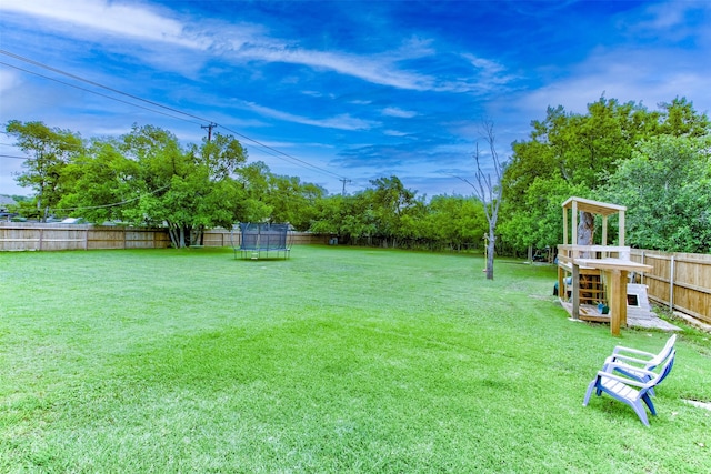 1201 Oakhurst Dr, Southlake, TX 76092 - view of yard featuring a trampoline, a playground, and view of wooded area