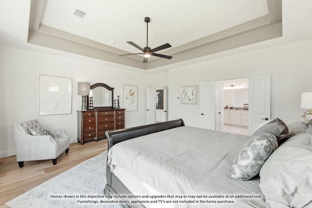 1422 Terrain Rd, Midlothian, TX 76065 - bedroom with a tray ceiling, light wood finished floors, and ensuite bath