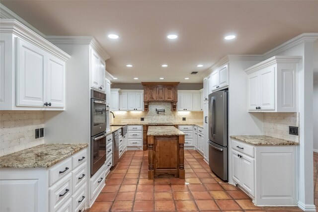 4624 County Road 206, Breckenridge, TX 76424 - kitchen with appliances with stainless steel finishes, tasteful backsplash, white cabinets, light stone counters, and recessed lighting