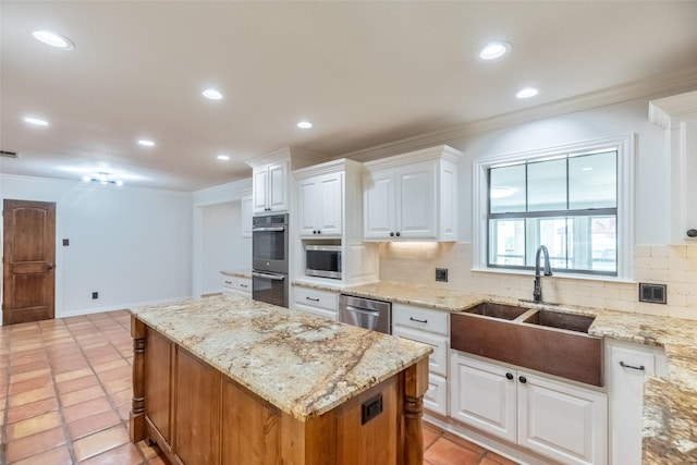 4624 County Road 206, Breckenridge, TX 76424 - kitchen with a sink, appliances with stainless steel finishes, tasteful backsplash, a center island, and crown molding