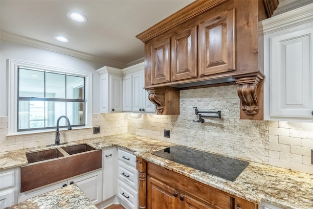 4624 County Road 206, Breckenridge, TX 76424 - kitchen with a sink, tasteful backsplash, black electric stovetop, crown molding, and white cabinets