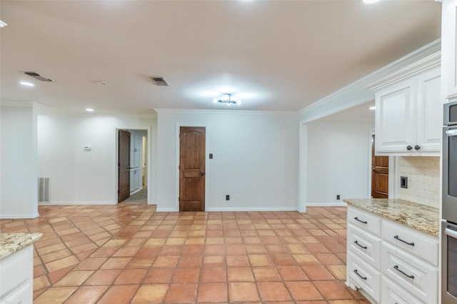 4624 County Road 206, Breckenridge, TX 76424 - kitchen with crown molding, white cabinets, recessed lighting, oven, and baseboards