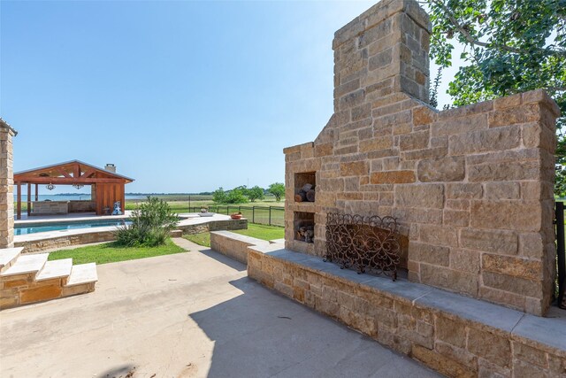 4624 County Road 206, Breckenridge, TX 76424 - view of patio with an outdoor stone fireplace and a gazebo