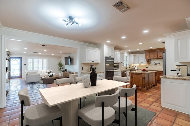 4624 County Road 206, Breckenridge, TX 76424 - dining area with ornamental molding, recessed lighting, and light tile patterned floors