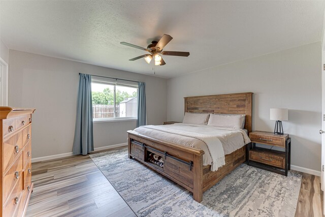 6117 Magnolia Ln, Rowlett, TX 75089 - bedroom with light wood-style floors, baseboards, and a ceiling fan