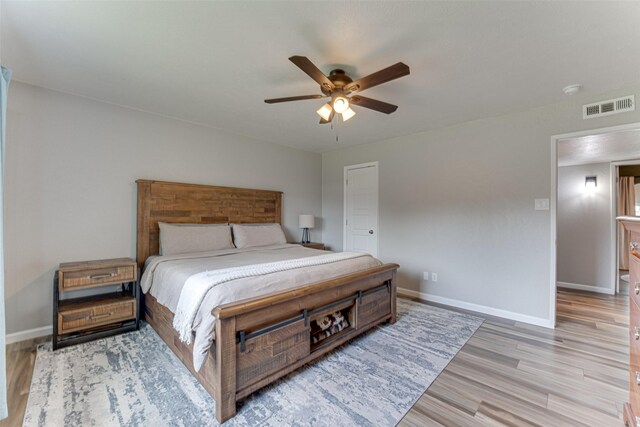 6117 Magnolia Ln, Rowlett, TX 75089 - bedroom with baseboards, light wood-style floors, and a ceiling fan
