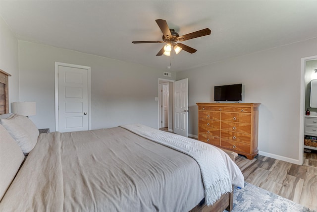 6117 Magnolia Ln, Rowlett, TX 75089 - bedroom featuring wood finished floors, baseboards, ensuite bathroom, and ceiling fan