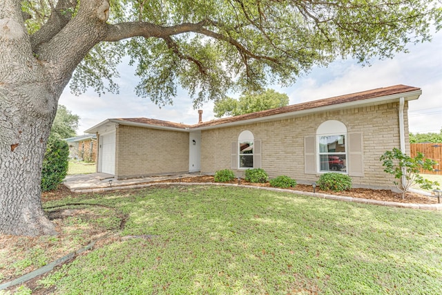6117 Magnolia Ln, Rowlett, TX 75089 - ranch-style house with an attached garage and brick siding