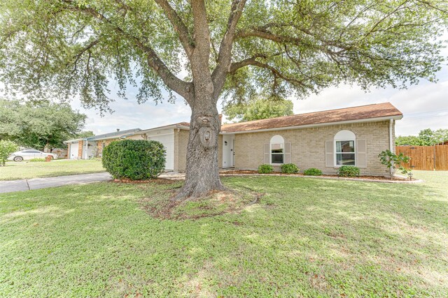 6117 Magnolia Ln, Rowlett, TX 75089 - ranch-style house with an attached garage, brick siding, and concrete driveway