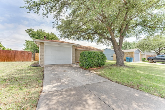 6117 Magnolia Ln, Rowlett, TX 75089 - view of front of home with driveway, a garage, and brick siding