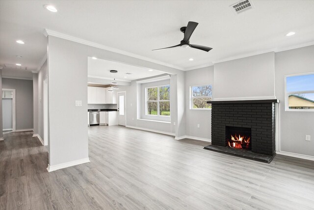 1250 E Morphy St, Fort Worth, TX 76104 - unfurnished living room with ornamental molding, ceiling fan, a fireplace, baseboards, and wood finished floors