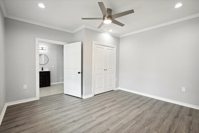 1250 E Morphy St, Fort Worth, TX 76104 - unfurnished bedroom with wood finished floors, recessed lighting, ornamental molding, baseboards, and a closet