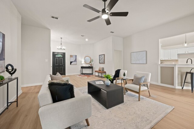 28 Alamosa Dr, Trophy Club, TX 76262 - living room featuring light wood finished floors, a chandelier, a ceiling fan, and baseboards