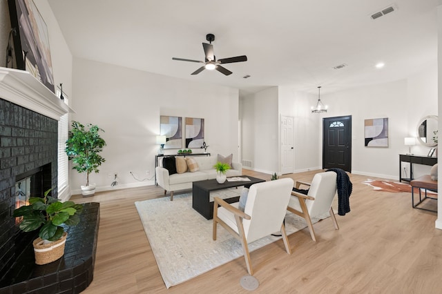28 Alamosa Dr, Trophy Club, TX 76262 - living area featuring light wood finished floors, a fireplace, baseboards, a ceiling fan, and a chandelier