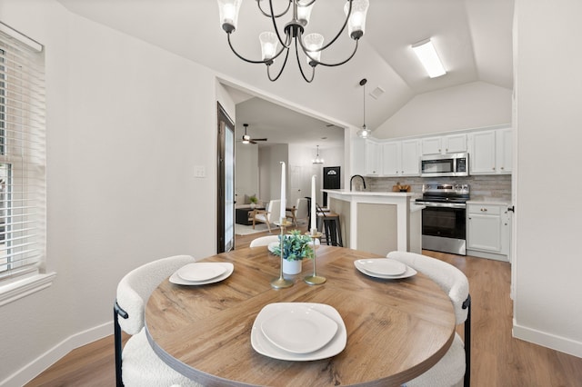 28 Alamosa Dr, Trophy Club, TX 76262 - dining room with lofted ceiling, a chandelier, baseboards, and light wood-style floors