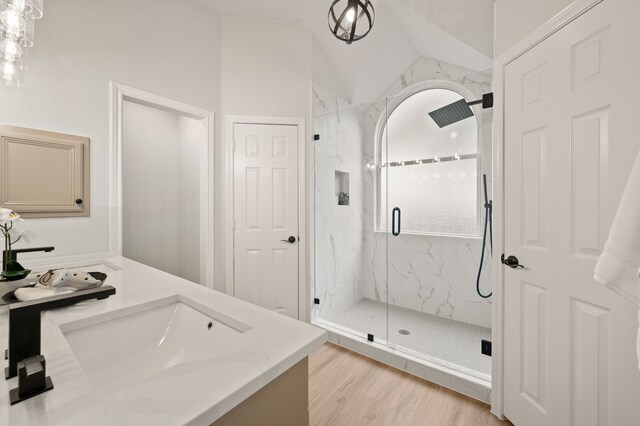 28 Alamosa Dr, Trophy Club, TX 76262 - bathroom featuring vaulted ceiling, vanity, a marble finish shower, and wood finished floors