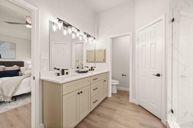 28 Alamosa Dr, Trophy Club, TX 76262 - bathroom featuring connected bathroom, double vanity, toilet, and wood finished floors