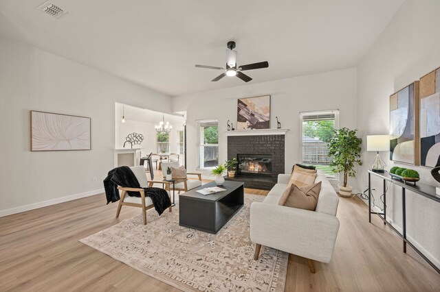 28 Alamosa Dr, Trophy Club, TX 76262 - living area featuring wood finished floors, a ceiling fan, a brick fireplace, a chandelier, and baseboards
