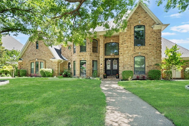 3303 Queensbury Way W, Colleyville, TX 76034 - view of front of home featuring brick siding, a front lawn, and french doors