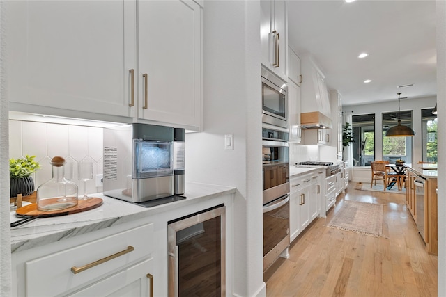 1525 Langford Ln, Celina, TX 75009 - kitchen with wine cooler, stainless steel appliances, white cabinets, light wood-style flooring, and recessed lighting