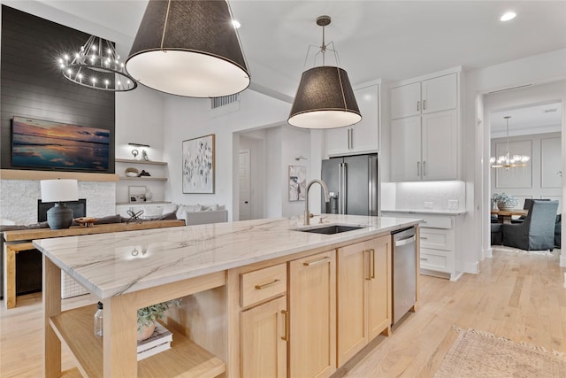 1525 Langford Ln, Celina, TX 75009 - kitchen featuring a chandelier, stainless steel appliances, light wood-type flooring, a sink, and open shelves