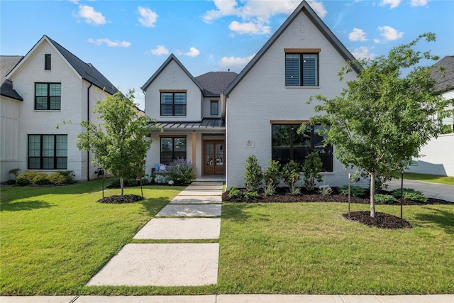 1525 Langford Ln, Celina, TX 75009 - view of front of home featuring french doors, a front yard, brick siding, and a standing seam roof
