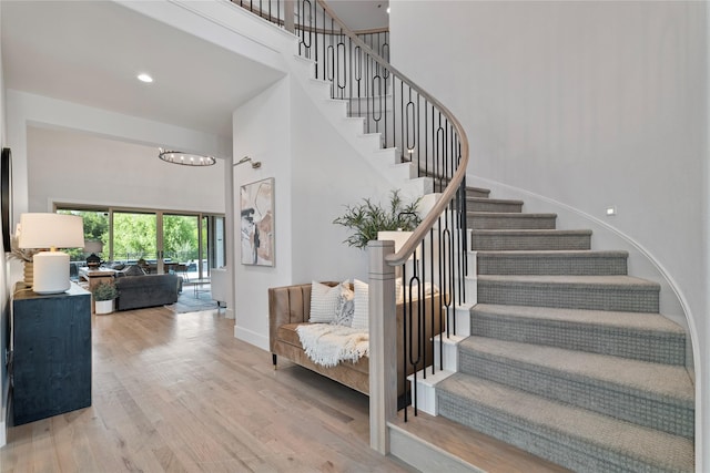 1525 Langford Ln, Celina, TX 75009 - stairway with a high ceiling, wood finished floors, baseboards, a chandelier, and recessed lighting